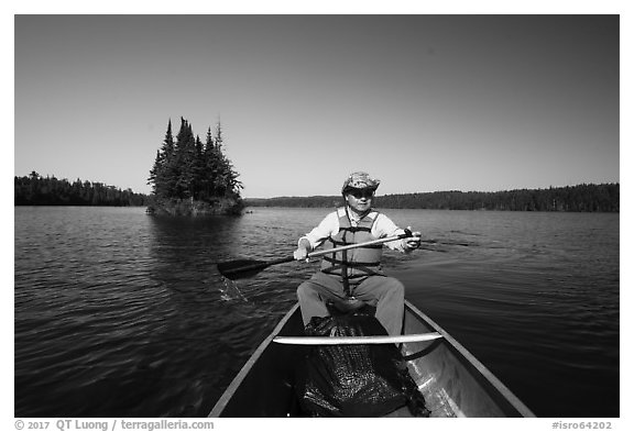 Canoist paddling and islet, Tobin Harbor. Isle Royale National Park (black and white)