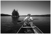 Canoist paddling and islet, Tobin Harbor. Isle Royale National Park ( black and white)