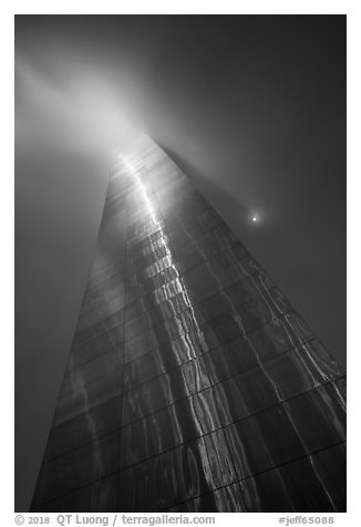 Moon and Gateway Arch south pillar soaring into clouds. Gateway Arch National Park (black and white)