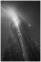 Moon and Gateway Arch south pillar soaring into clouds. Gateway Arch National Park ( black and white)