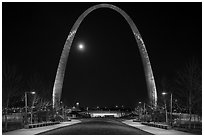 Arch at night and moon above new overpass. Gateway Arch National Park ( black and white)