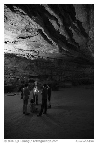 Ranger with lantern talks to family in cave. Mammoth Cave National Park (black and white)