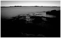 Slabs and distant trees at sunrise, Kabetogama lake near Woodenfrog. Voyageurs National Park, Minnesota, USA. (black and white)