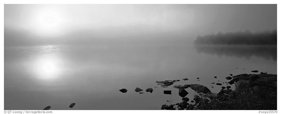 Misty lake scene with sun piercing fog, Kabetogama Lake. Voyageurs National Park (black and white)