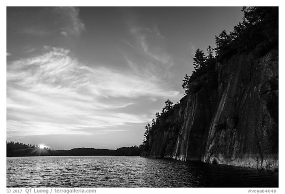 Sun setting and Grassy Bay Cliffs at sunset. Voyageurs National Park (black and white)