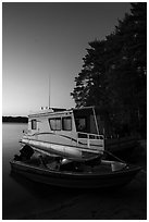 Motorboat and houseboat at dusk, Houseboat Island, Sand Point Lake. Voyageurs National Park ( black and white)