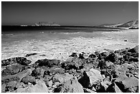 Surf foam and rocks, Cuyler Harbor, mid-day, San Miguel Island. Channel Islands National Park, California, USA. (black and white)