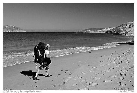 Backpacker on beach, Cuyler harbor, San Miguel Island. Channel Islands National Park, California, USA.
