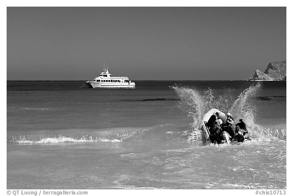 Skiff going back to main boat through surf, Cuyler harbor, San Miguel Island. Channel Islands National Park, California, USA.