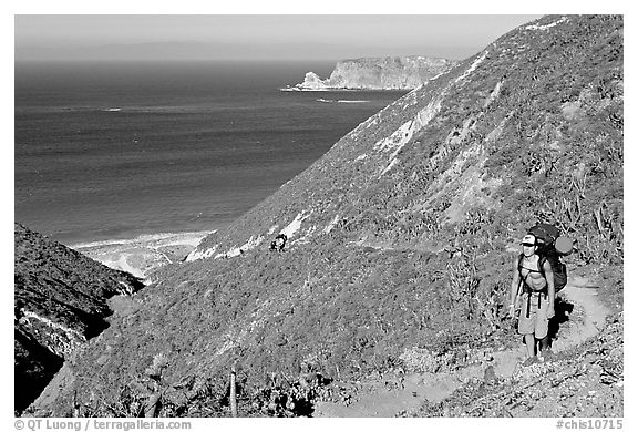 Backpacker going up Nidever canyon trail, San Miguel Island. Channel Islands National Park (black and white)
