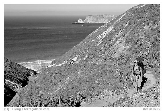 Backpacker going up Nidever canyon trail, San Miguel Island. Channel Islands National Park, California, USA.