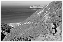 Backpacker going up Nidever canyon trail, San Miguel Island. Channel Islands National Park ( black and white)