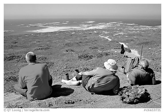 Hikers observing Point Bennett from a distance, San Miguel Island. Channel Islands National Park (black and white)