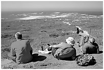 Hikers observing Point Bennett from a distance, San Miguel Island. Channel Islands National Park, California, USA. (black and white)