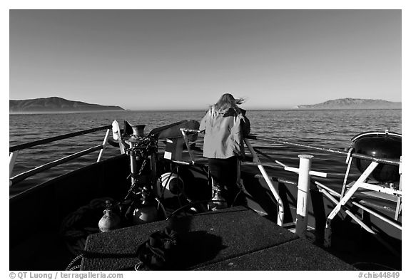 Woman standing on bow of boat sailing towards Annacapa and Santa Cruz Islands. Channel Islands National Park, California, USA.