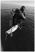 Scuba diver jumping from boat. Channel Islands National Park, California, USA. (black and white)