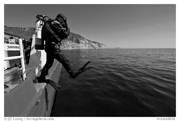 Scuba diver stepping out of boat, Santa Cruz Island. Channel Islands National Park (black and white)
