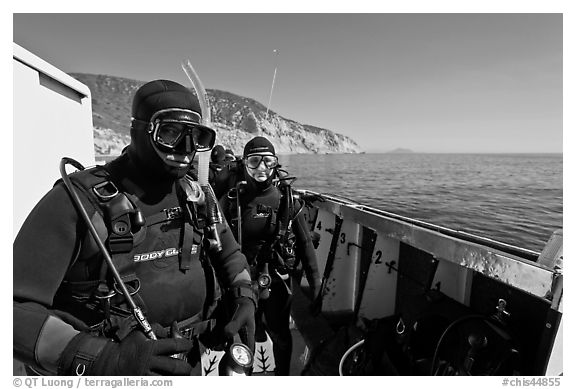 Scuba divers in wetsuits ready to dive from boat, Santa Cruz Island. Channel Islands National Park (black and white)