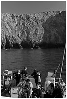 Dive boat and cliffs, Annacapa Island. Channel Islands National Park, California, USA. (black and white)