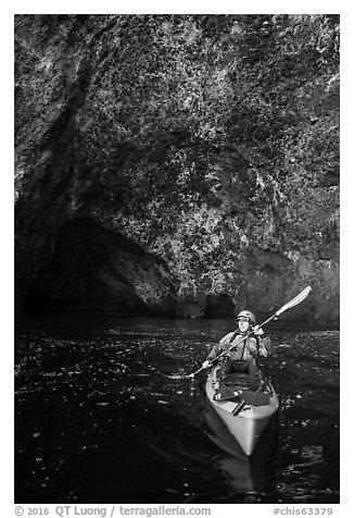 Kayaker near sea cave entrance, Santa Cruz Island. Channel Islands National Park (black and white)