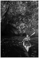 Kayaker near sea cave entrance, Santa Cruz Island. Channel Islands National Park ( black and white)