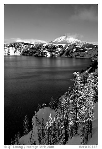 Lake rim in winter with blue skies. Crater Lake National Park, Oregon, USA.