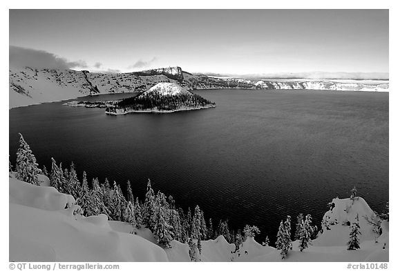 Wizard Island and lake in late afternoon shade, winter. Crater Lake National Park, Oregon, USA.