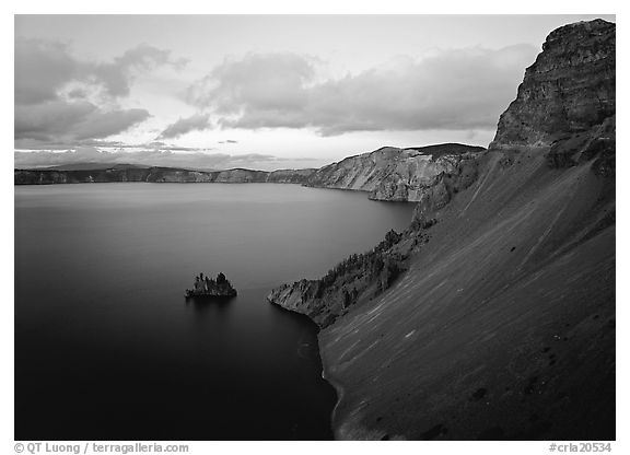Caldera slopes and Phantom ship at dusk. Crater Lake National Park, Oregon, USA.