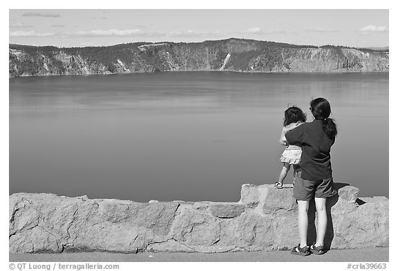 Woman and baby looking at Crater Lake. Crater Lake National Park, Oregon, USA.