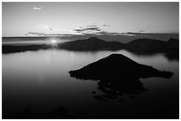 Sun rising below cloud band. Crater Lake National Park ( black and white)