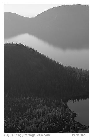 Wizard Island and crater rim profiles, early morning. Crater Lake National Park, Oregon, USA.