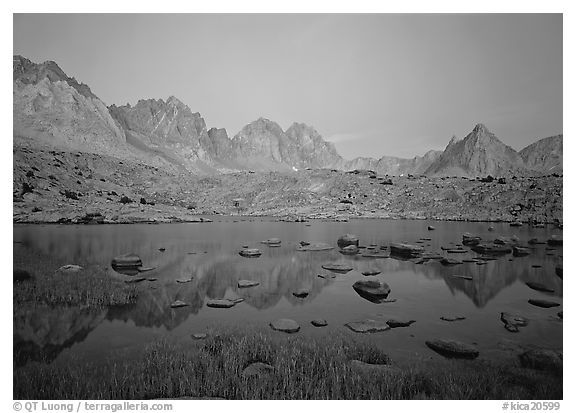 Mt Agasiz, Mt Thunderbolt, and Isoceles Peak reflected in a lake in Dusy Basin, sunset. Kings Canyon National Park, California, USA.