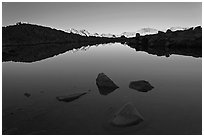 Rocks and calm lake with reflections, early morning, Dusy Basin. Kings Canyon National Park, California, USA. (black and white)