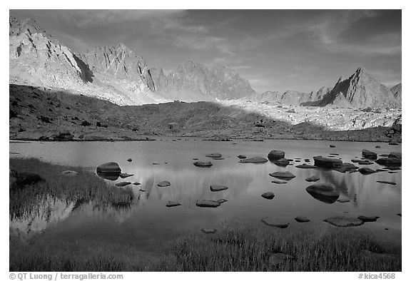 Mt Agasiz, Mt Thunderbolt, and Isoceles Peak reflected in a lake in Dusy Basin, late afternoon. Kings Canyon National Park, California, USA.