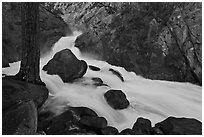 Forceful waterfall rushing through narrow granite chute. Kings Canyon National Park, California, USA. (black and white)