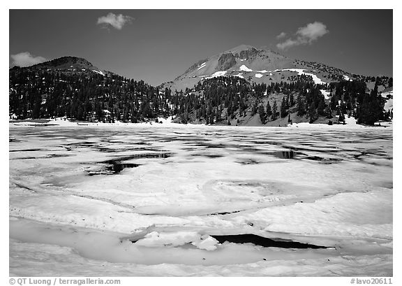 Helen Lake with Ice breaking up, and Lassen Peak. Lassen Volcanic National Park, California, USA.