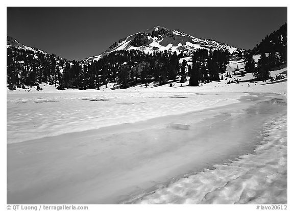 Turquoise melting snow in lake Helen and Lassen Peak, late spring. Lassen Volcanic National Park, California, USA.