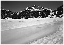 Turquoise melting snow in lake Helen and Lassen Peak, late spring. Lassen Volcanic National Park, California, USA. (black and white)