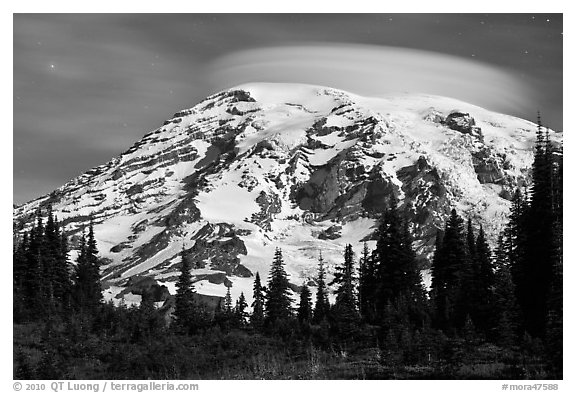 Mount Rainier capped by lenticular cloud, night. Mount Rainier National Park, Washington, USA.