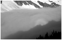 Sun projected on clouds filling Cascade River Valley,. Washington, USA. (black and white)
