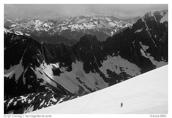 Mountain ridges, and mountaineers on snow field, North Cascades National Park.  (black and white)