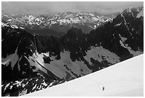 Mountain ridges, and mountaineers on snow field, North Cascades National Park. Washington, USA. (black and white)