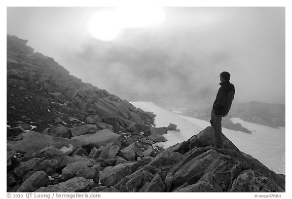 Visitor on ridge waches foggy sunset, North Cascades National Park.  (black and white)
