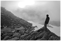 Visitor on ridge waches foggy sunset, North Cascades National Park. Washington, USA. (black and white)