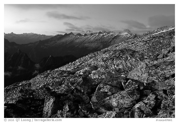 Rocky slope and distant range at dusk, North Cascades National Park.  (black and white)