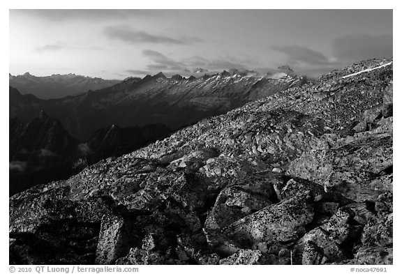 Rocky slope and distant range at dusk, North Cascades National Park.  (black and white)