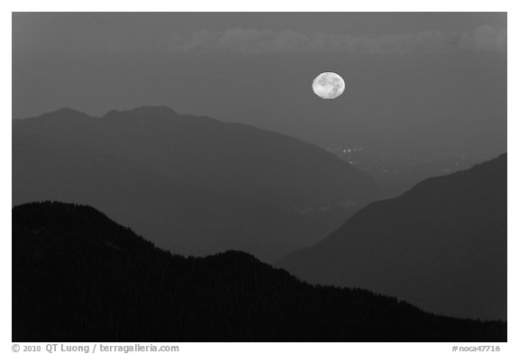 Moon setting over ridges, North Cascades National Park. Washington, USA.