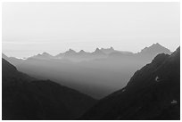 First sunrays lighting peaks above Cascade Pass, North Cascades National Park. Washington, USA. (black and white)