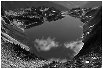 Fluffy clouds reflected in blue lake, North Cascades National Park.  ( black and white)