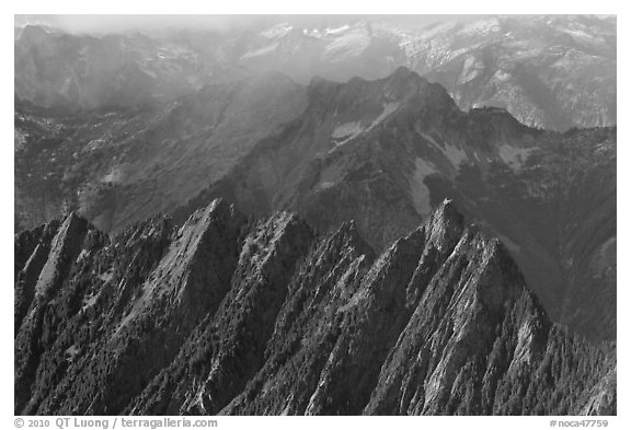 Steep forested spires in foggy light, North Cascades National Park.  (black and white)